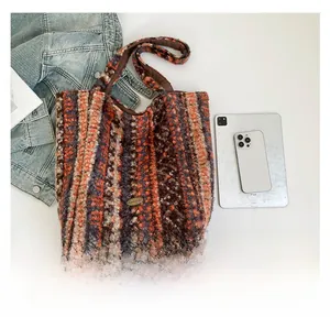 Detailed top view of striped fuzzy tote bag with accessories showing spacious capacity