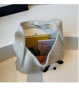 Detail shot of the large capacity white knit tote bag showing spacious inner storage