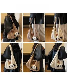 Detailed knit texture of a hobo shoulder bag featuring a cute dog plush patch on wide strap