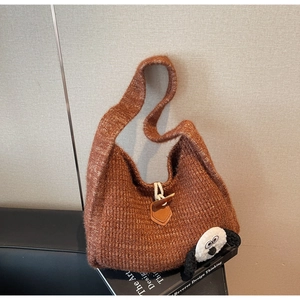 Detail of caramel knit tote bag showing chunky texture and sheep patch decoration