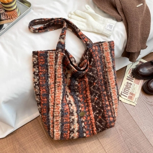 Detailed shot of the plush teddy fleece texture and striped pattern of the tote bag