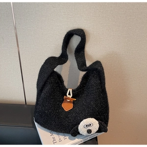 Detail of black fuzzy tote bag with soft plush texture and a cute sheep doll head