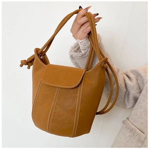 Detail of vintage bucket bag featuring white contrast stitching and knotted handle