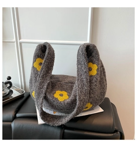 Détail du sac à bandoulière en tricot gris pelucheux avec broderies de fleurs jaunes