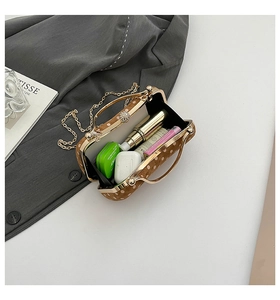 Detailed top view of a retro polka dot handbag showing its storage space and golden handle