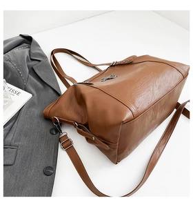 Brown faux leather tote bag detail with metal horse logo and silver star rivets