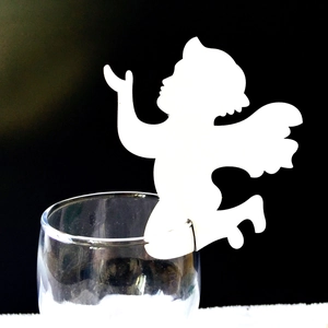 Laser-cut white angel decorative paper card for party glassware on black background