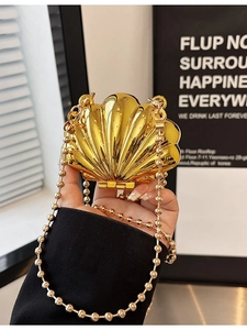Golden shell-shaped metal clutch evening bag with elegant ball chain strap for women