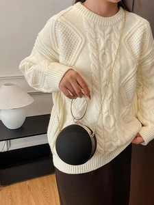 Elegant black spherical evening clutch with gold metal handle and long chain shoulder strap