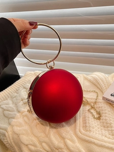 Elegant red spherical evening bag with golden round handle and metal chain strap