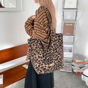 Detail of leopard print plush tote bag showing soft faux fur texture and large capacity