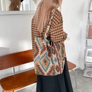 Detail of a large ethnic style tote bag with colorful geometric patterns and wide strap