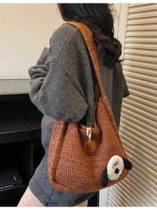 Caramel brown knitted tote bag with cute dog patch shown on model for autumn style