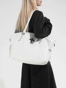 Large white leather tote bag with black cross badge and star details in gothic style