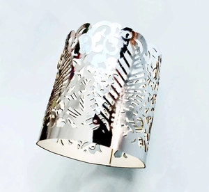 Detailed close-up of a silver hollowed-out feather pattern metal wide cuff bracelet