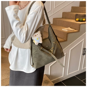 Olive green PU leather tote bag detail with front flap pocket and cute bear charm