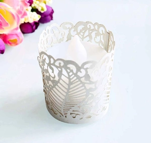 Close-up of laser-cut paper lampshade with vine patterns for LED tea light candle