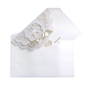 Laser cut white wedding invitation set with hollow heart pattern and champagne ribbon bow