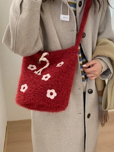 Winter red plush bucket bag with white floral crochet patterns and a long shoulder strap