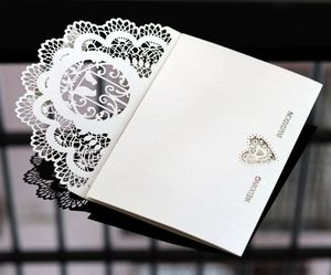 Elegant white laser-cut wedding invitation featuring hollow lace and swan silhouette