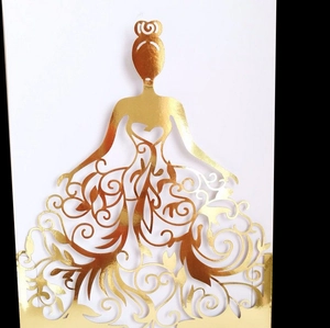 Intricate laser-cut gold greeting card featuring a female silhouette with floral gown