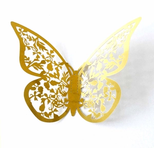 Detail of 3D laser-cut golden butterfly wall sticker with intricate floral patterns