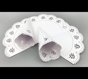 Detailed laser-cut white paper petal cones with intricate rose patterns and scalloped edges