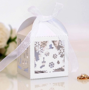 Detailed laser-cut white Christmas gift box with snowflake patterns and organza ribbon