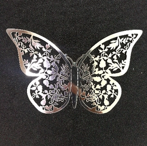 Detailed laser-cut silver butterfly ornament with intricate floral hollow patterns