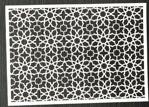 White laser-cut decorative paper sleeve with intricate geometric floral patterns on wood