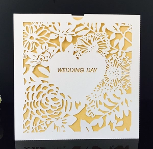 Elegant laser-cut heart wedding invitation with white floral cover and gold insert card