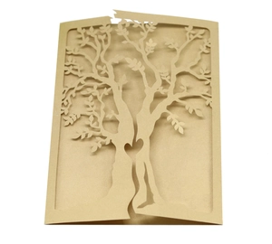 Close-up of laser-cut gold pearlescent card showing an intricate tree and heart design