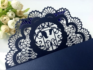 Detail of dark blue laser-cut card featuring intricate hollow lace and pearlescent texture