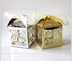 Laser-cut hollow gift boxes in gold and silver finish with elegant ribbon bow closures