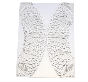 Detail of laser-cut leaf lace pattern on white pearlescent paper invitation cover