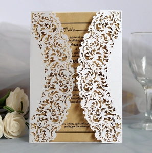 Macro detail of laser cut floral wedding invitation with kraft paper insert card