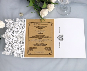 Elegant laser-cut hollow heart wedding invitation with brown kraft paper insert and floral detail