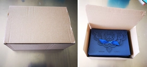 Navy blue hollow lace wedding invitation with ribbon detail in warehouse packaging