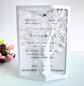 Detail of laser-cut tree of life wedding invitation with elegant hollow heart design