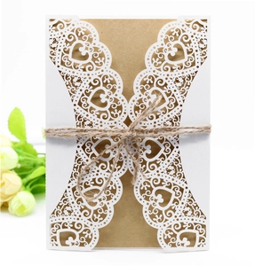 Detail of laser-cut heart and floral wedding card with kraft insert and jute twine