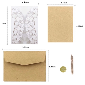 Laser cut white floral wedding invitation set with kraft inserts and envelopes