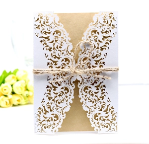 Detail of laser-cut lace invitation with kraft paper card and decorative jute twine