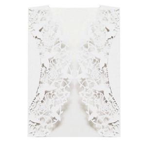 Detail of white laser-cut invitation card with floral and butterfly patterns