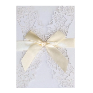 Elegant laser cut white wedding invitation featuring pink ribbon bow and butterfly motifs