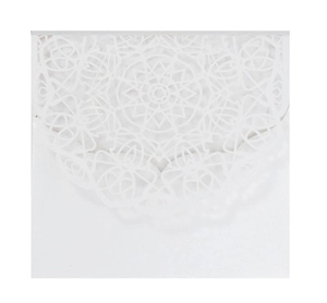 Detailed laser-cut mandala patterns on a white wedding invitation envelope