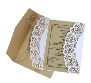 Detail of laser-cut heart invitation set with kraft envelope and rustic hemp rope