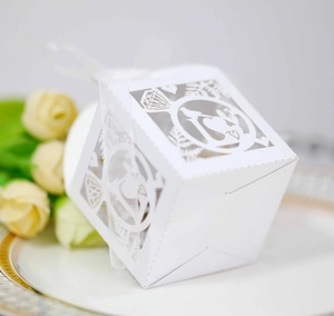 Laser cut white wedding favor box with diamond ring motif and elegant silk ribbon