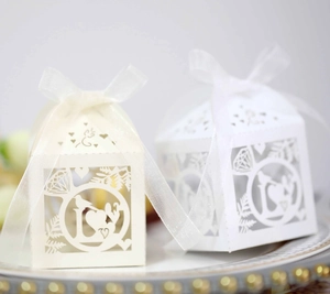 Detailed laser cut ivory paper candy box with diamond ring and bird patterns and white ribbon