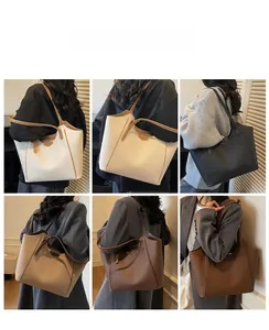 Collage of large tote bags in six colors being worn by models in a minimalist indoor setting