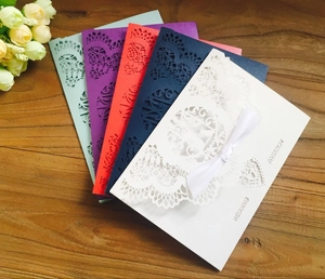Detailed laser-cut wedding invitations in five colors with elegant lace patterns and ribbons